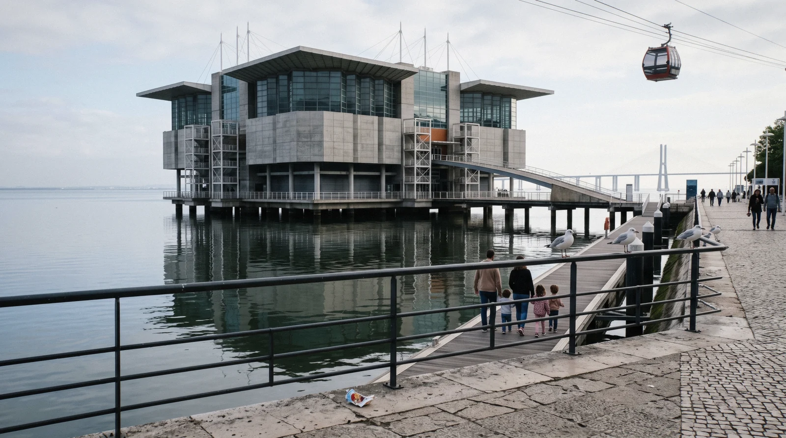 The Oceanário de Lisboa building on its pier in the Doca dos Olivais at 09:50 with the cable car passing above, Lisbon Oceanarium in Parque das Nações