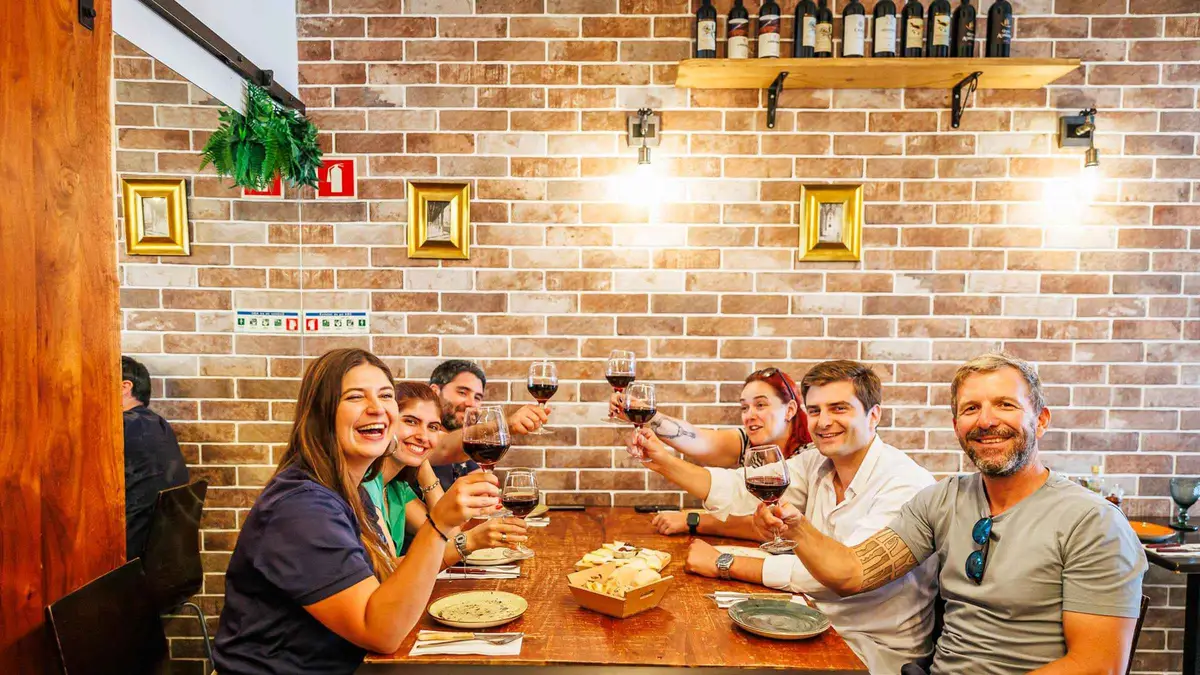 Plates of petiscos and glasses of Portuguese wine on a Lisbon food and wine small-group walking tour