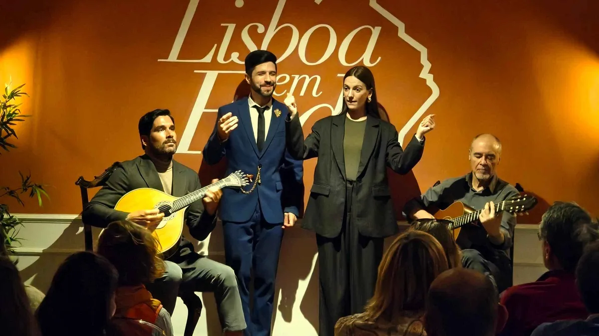 Portuguese guitar player on a small stage at the Lisboa em Fado live Fado and Port wine show in Lisbon