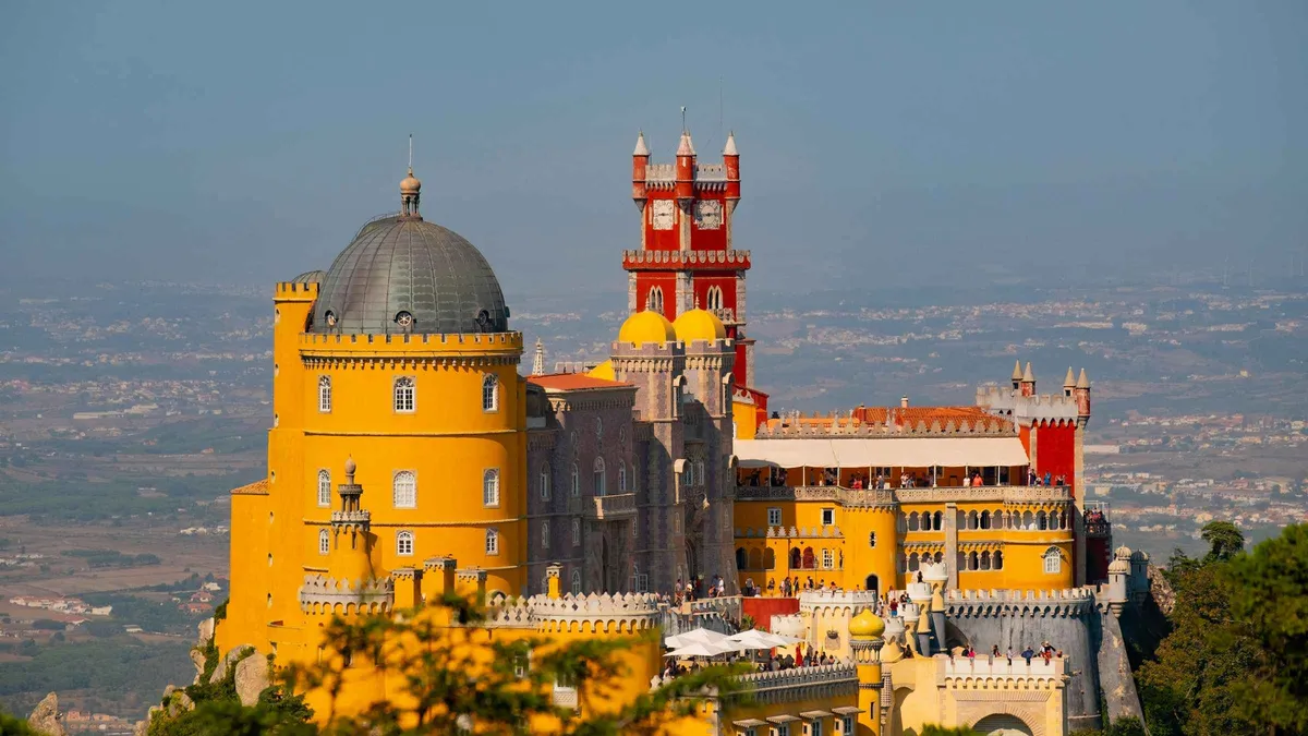 Guide with a group on the terraces of Pena Palace on a Sintra half-day tour with Pena Palace tickets from Lisbon